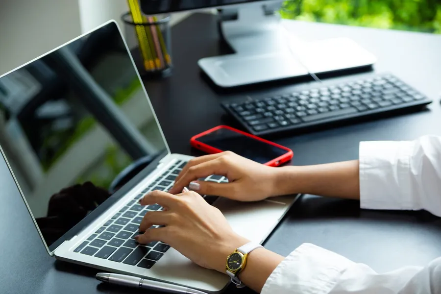 Typing on a laptop